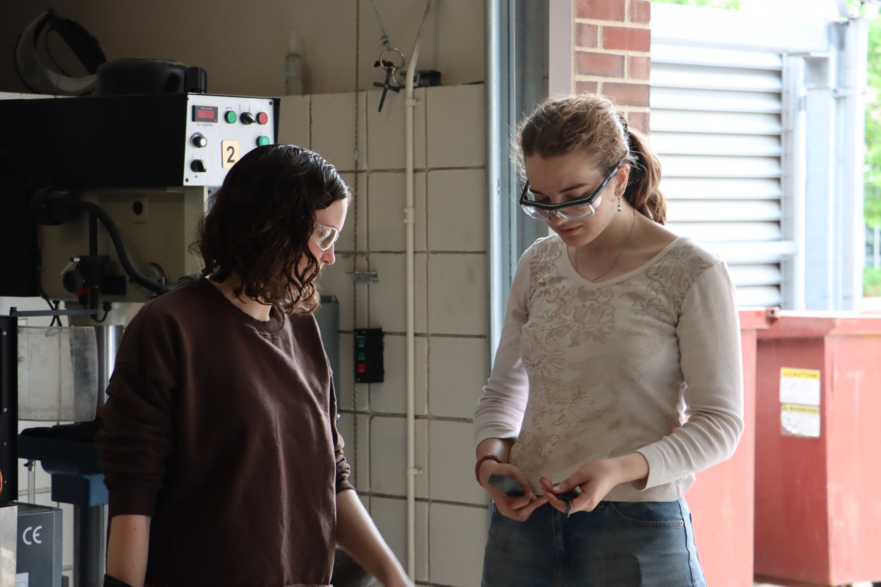 Discussing work in the blacksmithing lab