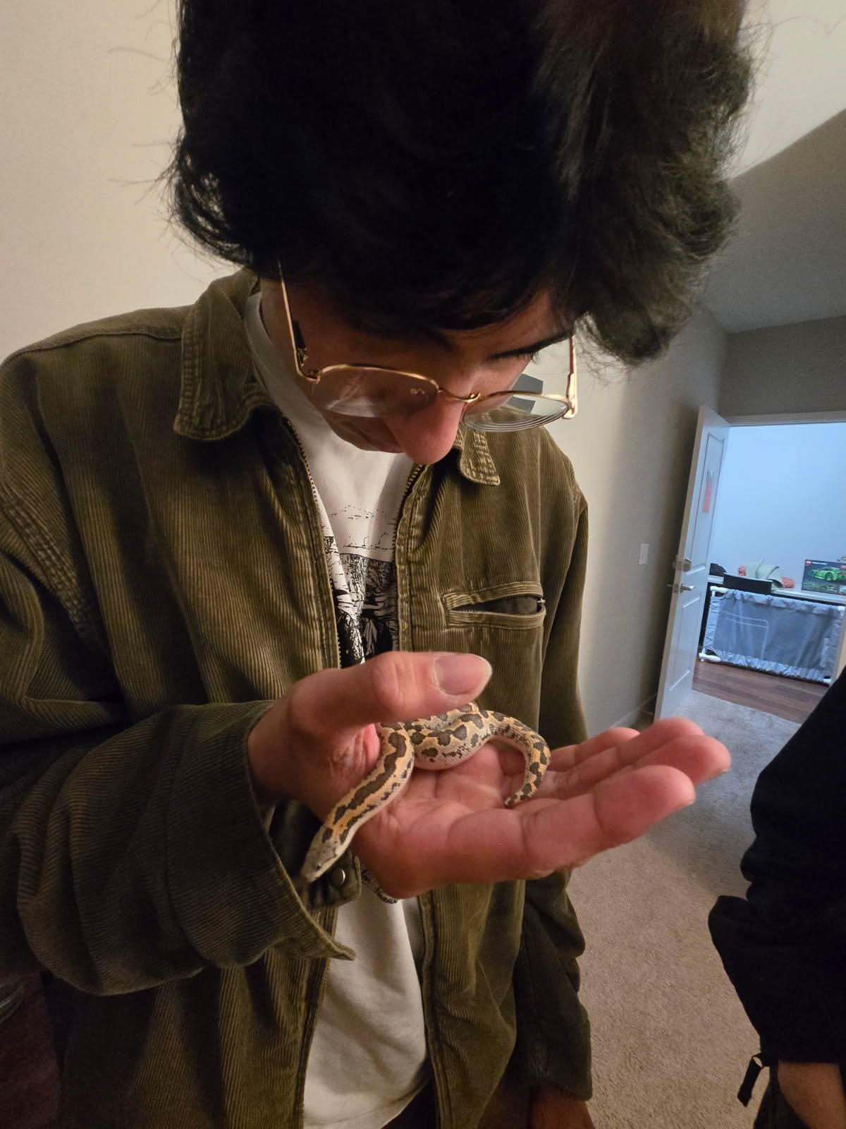 Ayush looking at a snake resting in his hands