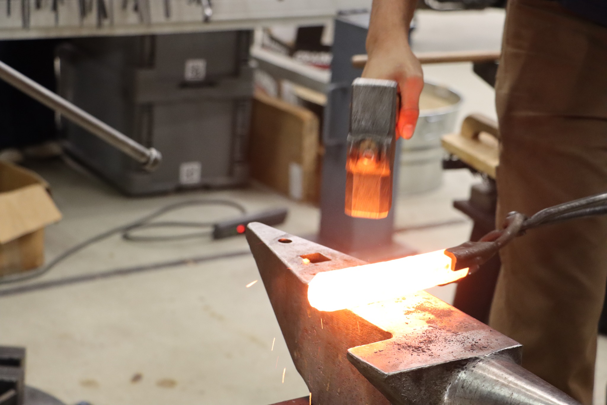 Hammering hot steel at the anvil