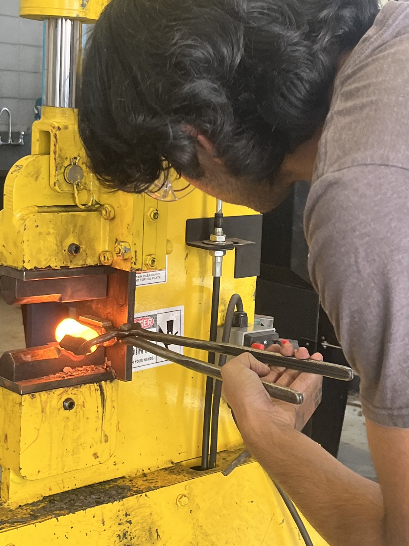 Working a heated piece at the power hammer